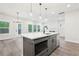 Modern kitchen with large island, stainless steel appliances and view to living spaces at 4785 Marjorie Dr, Cumming, GA 30041