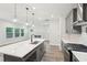 This kitchen features a stainless steel sink in the island, stainless steel appliances, and views of the living room at 4785 Marjorie Dr, Cumming, GA 30041