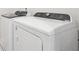 Modern laundry room with white washer and dryer at 4785 Marjorie Dr, Cumming, GA 30041