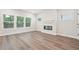 Bright living room with hardwood flooring, modern fireplace, and large windows, ideal for relaxation and entertainment at 4785 Marjorie Dr, Cumming, GA 30041
