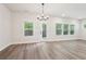 Bright living room with hardwood floors, a chandelier, and multiple windows at 4785 Marjorie Dr, Cumming, GA 30041