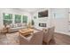 Staged living room featuring hardwood floors, a contemporary fireplace, and comfortable seating arrangements at 4785 Marjorie Dr, Cumming, GA 30041