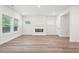 Open living area with hardwood floors, recessed lighting, and a modern fireplace providing a cozy focal point at 4785 Marjorie Dr, Cumming, GA 30041