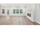 Bright and spacious living room with hardwood flooring, a modern fireplace, and large windows at 4785 Marjorie Dr, Cumming, GA 30041