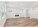 Spacious living room with fireplace, hardwood floors, and plenty of natural light at 4785 Marjorie Dr, Cumming, GA 30041