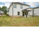 Home exterior and view of backyard with seeded lawn; covered patio is visible at 4830 Marjorie Dr, Cumming, GA 30041