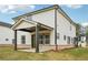 View of the home's backyard with a covered patio featuring dark support columns at 4830 Marjorie Dr, Cumming, GA 30041