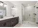 Bathroom featuring a double sink vanity, tile floors, and a glass-enclosed shower at 4830 Marjorie Dr, Cumming, GA 30041
