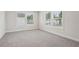 Bright bedroom featuring neutral walls, soft carpet, and large windows letting in natural light at 4830 Marjorie Dr, Cumming, GA 30041