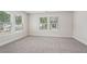 Bedroom featuring carpet, base trim and two windows at 4830 Marjorie Dr, Cumming, GA 30041