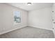 Cozy bedroom with soft carpet, neutral walls, and a window at 4830 Marjorie Dr, Cumming, GA 30041