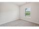 Bedroom with neutral carpet, a window and base trim at 4830 Marjorie Dr, Cumming, GA 30041