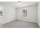 Empty bedroom with soft carpet and a window letting in natural light at 4830 Marjorie Dr, Cumming, GA 30041