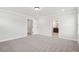 An empty bedroom featuring neutral paint colors, plush carpet, and doorways to other rooms at 4830 Marjorie Dr, Cumming, GA 30041
