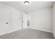 Comfortable bedroom with soft carpet, neutral walls, and a white door at 4830 Marjorie Dr, Cumming, GA 30041