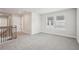 Open bonus room area with soft carpet, a staircase, and natural light from a large window at 4830 Marjorie Dr, Cumming, GA 30041