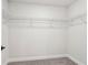 Walk-in closet featuring wire shelving and plush neutral carpet at 4830 Marjorie Dr, Cumming, GA 30041