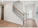 Bright foyer features hardwood floors, stairs with iron spindles, and a glass paneled front door at 4830 Marjorie Dr, Cumming, GA 30041