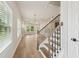 Entryway with natural light, hardwood flooring, stairs with wood and iron banister at 4830 Marjorie Dr, Cumming, GA 30041