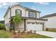 Two-story house shows a two-car garage, lawn, and landscaped beds at 4830 Marjorie Dr, Cumming, GA 30041