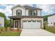 New construction home features a two-car garage and a combination brick and siding facade at 4830 Marjorie Dr, Cumming, GA 30041