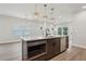 Kitchen featuring island with built in microwave and stainless steel dishwasher at 4830 Marjorie Dr, Cumming, GA 30041