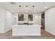 Open concept kitchen with a large island, stainless steel appliances, and modern lighting at 4830 Marjorie Dr, Cumming, GA 30041