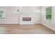 Bright living room featuring a modern fireplace, with hardwood floors and natural light at 4830 Marjorie Dr, Cumming, GA 30041