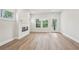 Open living space with fireplace, mantle, and large windows provides plenty of natural light at 4830 Marjorie Dr, Cumming, GA 30041