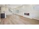 Spacious living room with a modern fireplace, open floor plan, and wood floors at 4830 Marjorie Dr, Cumming, GA 30041