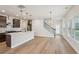 Open concept kitchen flows into the Gathering room, showcasing hardwood floors and modern fixtures at 4830 Marjorie Dr, Cumming, GA 30041