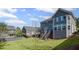 A large lawn with an elevated wooden deck and stairs leading down to the grass at 5153 Elkins Ln, Acworth, GA 30101