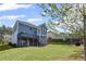 Expansive green backyard featuring a two-story home with a deck and stairs leading down to the lawn at 5153 Elkins Ln, Acworth, GA 30101