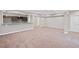 Large basement area featuring a wet bar with granite counters, cabinets, and a doorway at 5153 Elkins Ln, Acworth, GA 30101