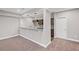 Basement area with a wet bar featuring granite countertops and brown cabinetry at 5153 Elkins Ln, Acworth, GA 30101