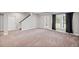 Spacious carpeted basement area with a door to the outside and a staircase leading to the upper level at 5153 Elkins Ln, Acworth, GA 30101