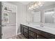 Bright bathroom features a double sink vanity with dark cabinets and a large mirror; access to bedroom visible at 5153 Elkins Ln, Acworth, GA 30101