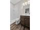 Bathroom featuring a walk-in shower, toilet, and vanity with brown cabinets at 5153 Elkins Ln, Acworth, GA 30101