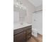 Well-lit bathroom with a dark wood vanity, a bright mirror, and a shower with tiled walls at 5153 Elkins Ln, Acworth, GA 30101