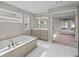 This bathroom features a soaking tub with tile surround and dual windows at 5153 Elkins Ln, Acworth, GA 30101