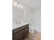 This bathroom features a dark wood vanity, a combined bath and shower, and white fixtures at 5153 Elkins Ln, Acworth, GA 30101