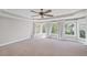 A light filled bedroom has neutral colors, tray ceiling, ceiling fan and large windows at 5153 Elkins Ln, Acworth, GA 30101