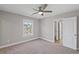 This bedroom features a neutral color palette, plush carpet, and a ceiling fan at 5153 Elkins Ln, Acworth, GA 30101