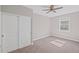 Cozy bedroom with neutral walls, carpet flooring, a ceiling fan, and closet with sliding doors at 5153 Elkins Ln, Acworth, GA 30101