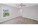 This bedroom features a neutral color palette, plush carpet, and ceiling fan at 5153 Elkins Ln, Acworth, GA 30101