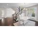Open-concept dining area featuring modern lighting, access to the outdoors, and elegant staircase at 5153 Elkins Ln, Acworth, GA 30101