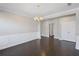 Formal dining room with dark hardwood floors, wainscoting, and a classic chandelier for an elegant touch at 5153 Elkins Ln, Acworth, GA 30101