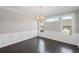 Dining room features dark hardwood floors, classic wainscoting, and plenty of natural light from the windows at 5153 Elkins Ln, Acworth, GA 30101