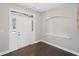 Bright foyer with a white front door featuring sidelights and transom window, and dark hardwood flooring at 5153 Elkins Ln, Acworth, GA 30101