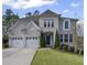 Charming two-story home with a manicured lawn and a two-car garage at 5153 Elkins Ln, Acworth, GA 30101